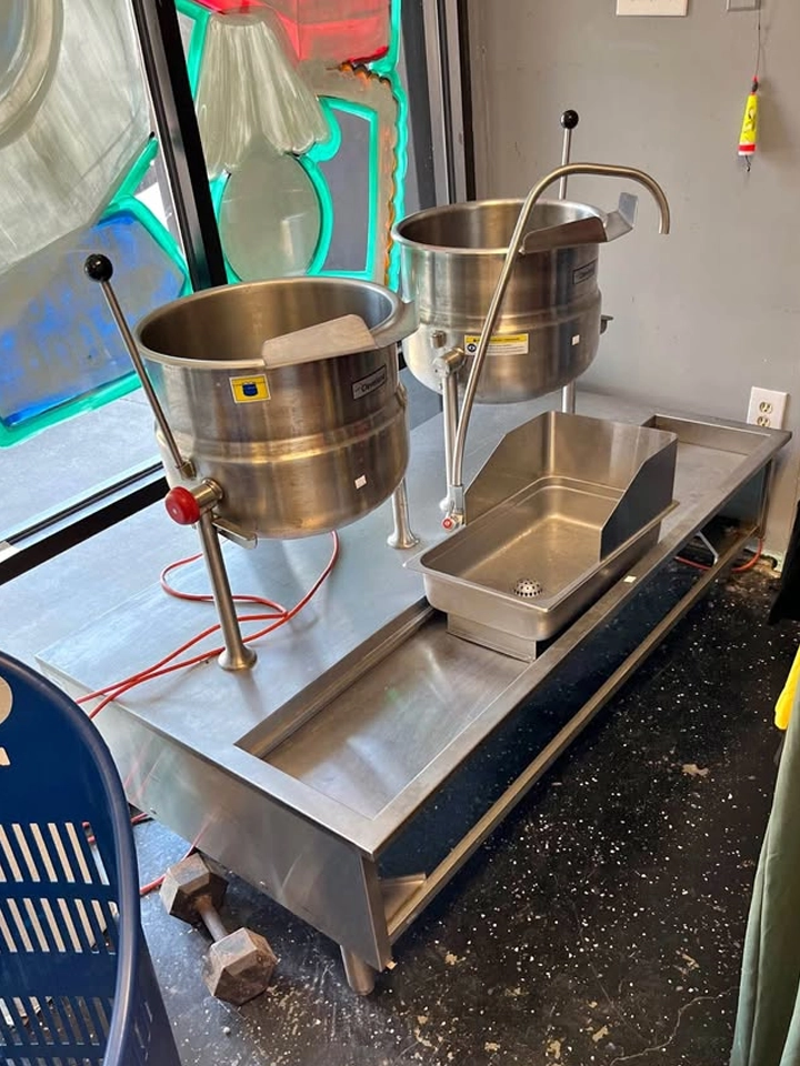 Cleveland Range double steam jacketed kettle station with stainless base and built-in sink